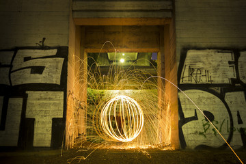 Light painting / light drawing with fire and steel wool in the city
