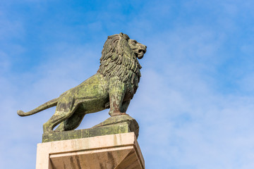 Sculpture of a lion against a blue sky, Zaragoza, Spain. Copy space for text.