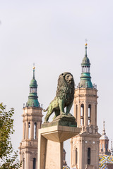 Sculptures of lions on the background of the Cathedral-Basilica of Our Lady of the Pillar, Zaragoza, Spain. Close-up. Vertical.
