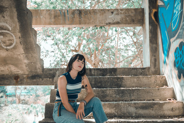 Portrait of asian beautiful teen girl in hipsters style The abandoned building vintage tone