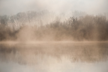 Fototapeta na wymiar Morning on the river early morning reeds mist fog and water surface on the river