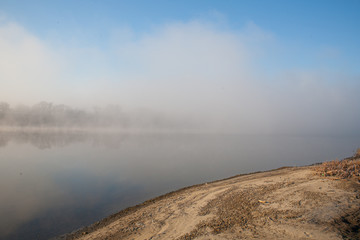 Morning on the river early morning reeds mist fog and water surface on the river