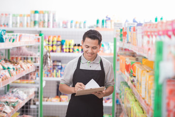 male shopkeeper working in a grocery store