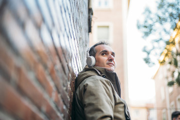 Man listens to music with headphones and smart phone.