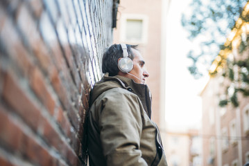 Man listens to music with headphones and smart phone.