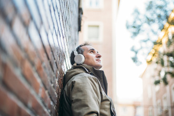 Man listens to music with headphones and smart phone.