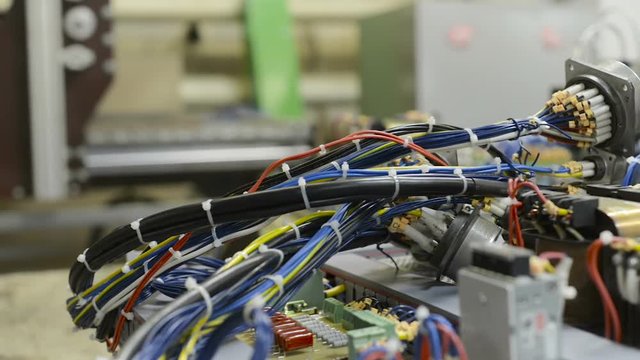 Harnesses of electrical cables lie on the circuit board.