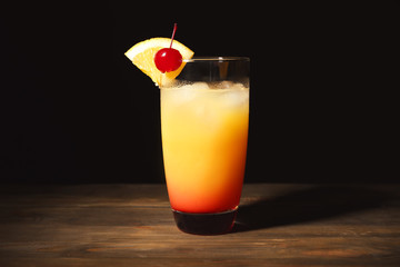 Glass with tasty sex on the beach cocktail on table
