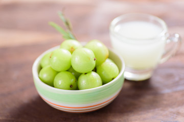 Indian gooseberry fruit and juice on wooden background,healthy food