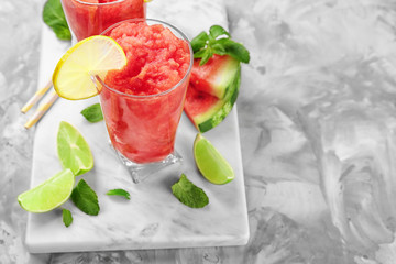 Glass of fresh watermelon smoothie on table