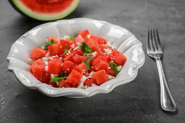 Bowl with delicious watermelon salad on table
