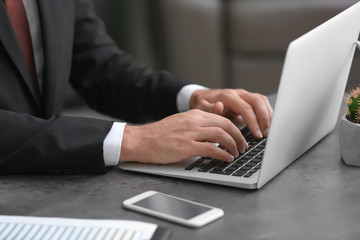 Businessman using his laptop while working in office