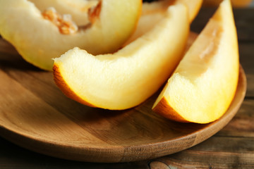 Ripe melon on wooden plate