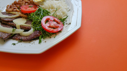 Brazilian food dish on orange background