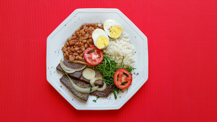 Brazilian food dish on red background