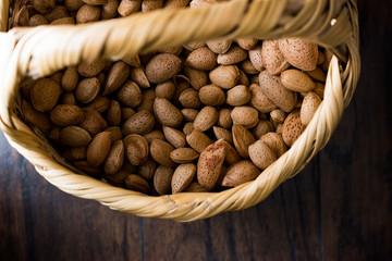 Fresh Organic Raw Almonds with Shell in Basket.