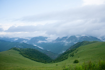 Fototapeta na wymiar Landscape high mountains in dense fog tops of mountains in clouds North Caucasus Elbrus