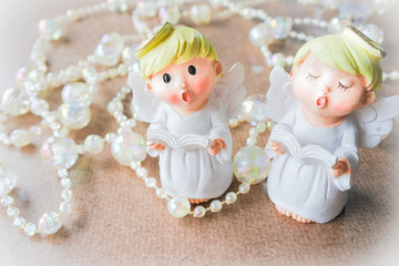 The angles sing, with thread of crystal beads on wood background. Lovely and twinkle in Christmas season greeting for family and friend.