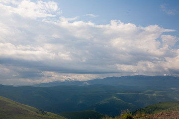 Landscape high mountains in dense fog tops of mountains in clouds North Caucasus Elbrus