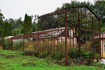 Rusty abandoned construction of old greenhouse
