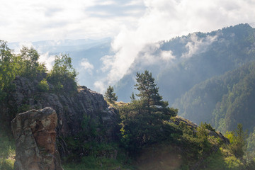 Landscape high mountains in dense fog tops of mountains in clouds North Caucasus Elbrus