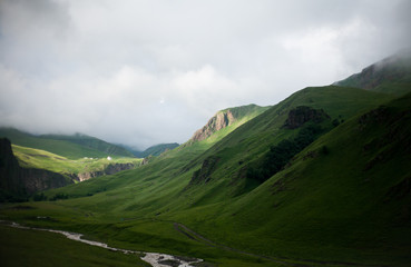 Landscape high mountains in dense fog tops of mountains in clouds North Caucasus Elbrus
