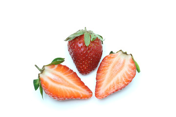 Two sliced fresh strawberries and a fresh strawberry on white background ,isolated