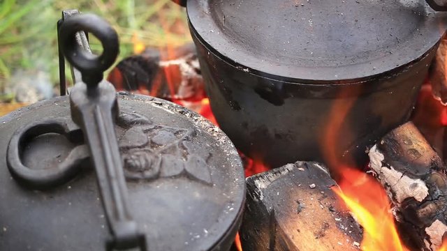 Food preparation on a campfire in a traditional high-pressure pot