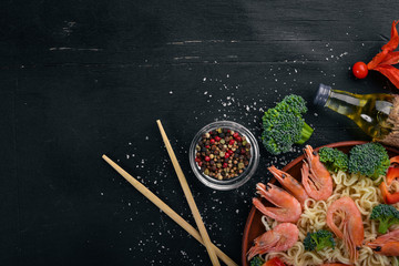 Asian food with seafood and vegetables. Shrimp, broccoli, paprika, spices. Top view. Free space for text.