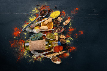 Spices and herbs. A large assortment of spices. Indian cuisine. On the wooden table. Top view. Free space for text.