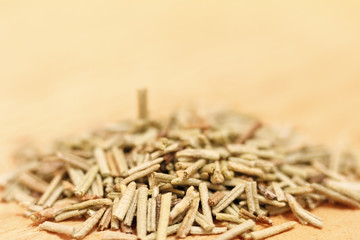 Heap of dried rosemary on a wooden background