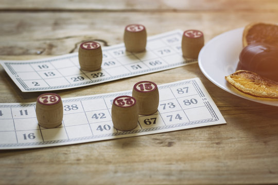 Tabletop old lotto game with wooden elements. Biscuits and dried orange