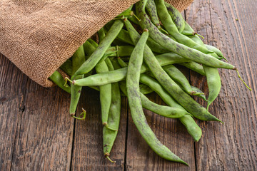 Green beans pods on a wooden table