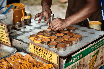 Langkawi, Malaysia – November 2017: Cooking of Dorayaki, traditional asian sweet pancakes with coconut milk inside. Classic asian street food from Langkawi island in Malaysia..