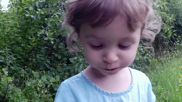 slow motion, cute girl eating cherry, fruits in the garden