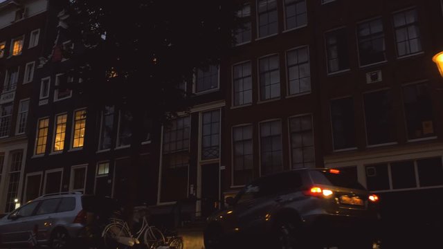 Residential buildings of Amsterdam at nightfall. Low angle.
