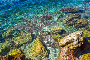 The sea view. Beautiful view from the mountain to the calm Adriatic sea. Blue clear water and large stones.