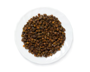 Propolis granules inside plate, bee product