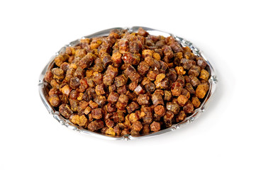 Propolis granules inside plate, bee product
