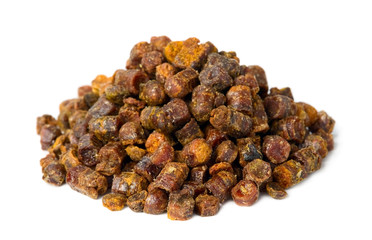 Propolis granules isolated on white background, bee product