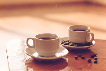 two  cups of black coffee on the table,toned