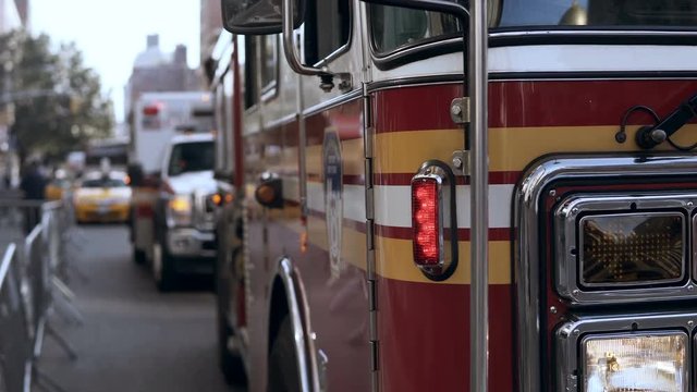 Close-up view of emergency service cars standing on the road. Accident in the city. Fire vehicle going work.