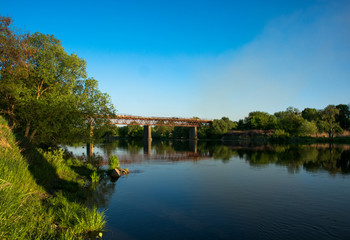 Fototapeta na wymiar Red Bridge across the river