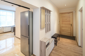 Refrigerator, metallic color, stainless steel in the kitchen.
