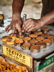 Cooking of Dorayaki, traditional asian sweet pancakes with coconut milk inside. Classic asian street food from Langkawi island in Malaysia.