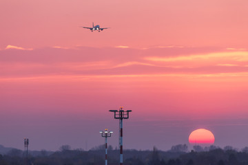 airplane landing at an airport in an evening sundown