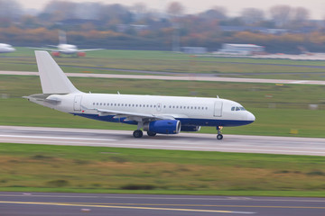 Fototapeta na wymiar airplane speeding at an airport runway