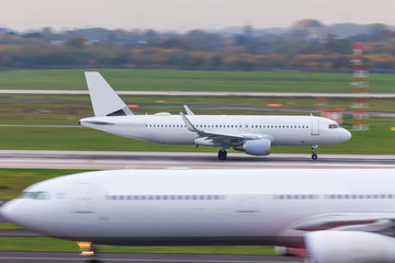 two airplanes speeding at an airport runway