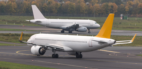 two airplanes speeding at an airport runway