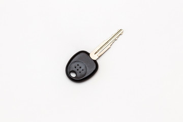 The key to the lock on a white background. The key to the door, car key.